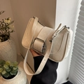 Chic beige crossbody underarm bag featuring a large silver buckle and adjustable strap - Off White