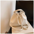 White faux leather drawstring bucket bag with silver eyelets and versatile strap - White