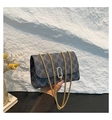 Close-up of retro crossbody bag with gray geometric pattern and gold chain strap - Black