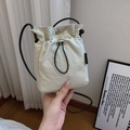 Minimalist beige nylon drawstring bucket bag with black thin shoulder strap - Off White