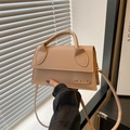 Elegant beige leather crossbody handbag with gold letter detail and top handle - Khaki