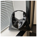 Close-up of black glossy leather moon bag with silver butterfly metallic details - Black