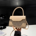 Beige quilted handbag with heart embroidery and top handle worn as a crossbody bag - Khaki