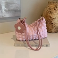 Pink bubble textured shoulder bag with floral charm and soft pleats in aesthetic setting - Pink