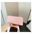 Detail of pink woven texture on long wallet with golden zipper and luxury finish - Pink