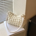 Chic cream bubble textured shoulder bag with a stylish knot strap and zipper detail - White