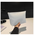 White clutch bag featuring a detailed woven texture and elegant gold zipper closure - Off White