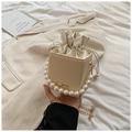 Elegant beige woven bucket bag with large pearl handle and gold chain strap - White