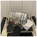 Detailed view of shimmering silver crossbody bag with a sparkling rhinestone bow and chain - Silver