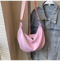 Detailed view of pink nylon crescent bag with wide strap and silver zipper closure - Pink