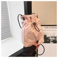 Minimalist light pink drawstring mini bucket bag with adjustable black shoulder strap - Pink
