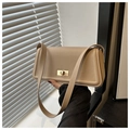 Close-up of the beige leather crossbody bag featuring a golden rectangular twist lock - Khaki