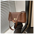 Detailed view of brown leather crossbody bag with golden metal rotating square buckle - Brown
