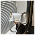 Detail of silver matte shoulder bag featuring a rectangular shape and golden metal twist lock - Silver
