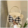 Detail of checkered tweed bag with faux leather flap and decorative wooden button - White