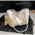 Close-up of cream floral jacquard tote bag with woven rope handles on black leather - White