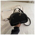 Fashionable black crescent shoulder bag with quilted texture and gold hardware zipper - Black