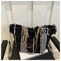 Dettaglio della borsa tote tessuta con strisce bianche e nere e manici in pelle marrone - Nero