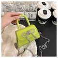 Close-up of vibrant neon green mini bag with sparkling rhinestone bow and silver chain - Green
