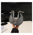 Detail of crescent houndstooth handbag with wavy golden hardware and matching strap - Houndstooth Style