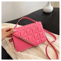 Detail of rose pink quilted crossbody bag featuring golden metal bar and textured finish - Pink