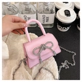 Detail of mini pink crossbody bag with sparkling rhinestone bow and metal chain strap - Pink