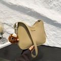 Minimalist beige large capacity crossbody bucket bag with fashion charm and matte finish - With Plush Charm / Khaki