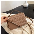 Close-up of caramel quilted crossbody bag with gold metal trim and elegant handle - Khaki