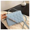 Close-up of light blue quilted crossbody bag with gold metal hardware and top handle detail - Blue
