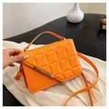 Detail of orange quilted crossbody bag with golden metal bar and structured top handle - Orange