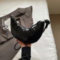 Minimalist black crescent moon bag in glossy faux leather with knotted shoulder strap - Black