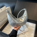 Minimalist metallic silver crescent bag with knot handle and stitched detail - Silver