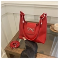 Red patent leather handbag with silver metal bow detail and knotted handle design - Red