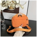 Close-up of orange nylon crossbody bag with black zipper detail and strap buckle - Orange