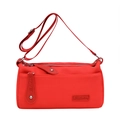 Chic red rectangular crossbody bag with adjustable strap and logo detail on white background - Red
