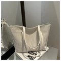Detailed view of the off-white tote bag featuring a unique marble texture and slim straps - No Pendant / Beige