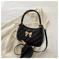 Elegant black quilted handbag with a gold bow accent and detachable crossbody strap - Black