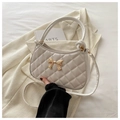 Quilted white crescent crossbody bag with golden bow accent and top handle detail - White