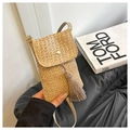 Detail of hand-woven straw phone bag with elegant tassels and gold buckle closure - Khaki