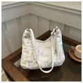 Detail of colorful embroidery textures and silver chain strap on a white quilted tote bag - White Without Pendant