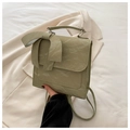 Macro detail of glossy sage green faux leather and large bow on a stylish handbag - Green