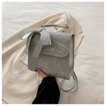 Detail of silver pleated handbag with large bow decoration and glossy metallic finish - Silver