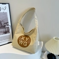 Large beige canvas tote bag with brown leather patch on a minimalist display stand - Yellow