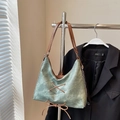 Detail view of green vintage tote with brown leather straps and bow lace-up design - Green