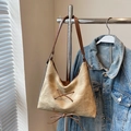 Detail of vintage khaki tote bag featuring brown faux leather lacing and decorative bow knots - Khaki