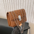 Brown quilted crossbody bag with silver chain strap and metal lock in a casual chic style - Brown