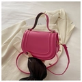 Detail of rose pink saddle bag with U-shaped embossing on a white blazer - Rose Pink