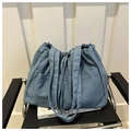 Large denim tote bag in washed blue with drawstring closure and multiple outer pockets - Lake Blue