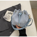 Light blue drawstring bucket bag featuring a woven strap and gold metal hardware - Blue Without Charm