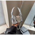 Sparkly silver sequin handbag with metal bow and chain strap in a modern indoor setting - Silver